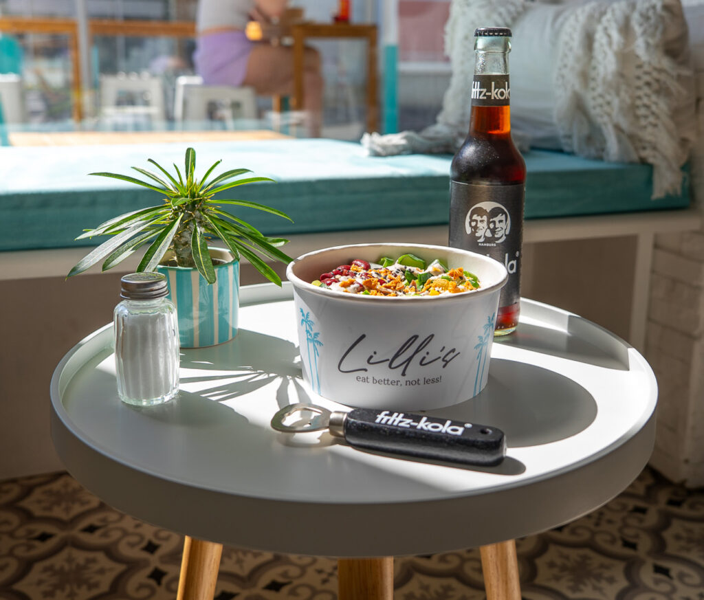 Nahaufnahme einer frischen Bowl mit einem Flaschenöffner und einer Fritz-Kola im Innenbereich der Lilli’s-Bowls Filiale in der Bahnhofsstraße Tulln